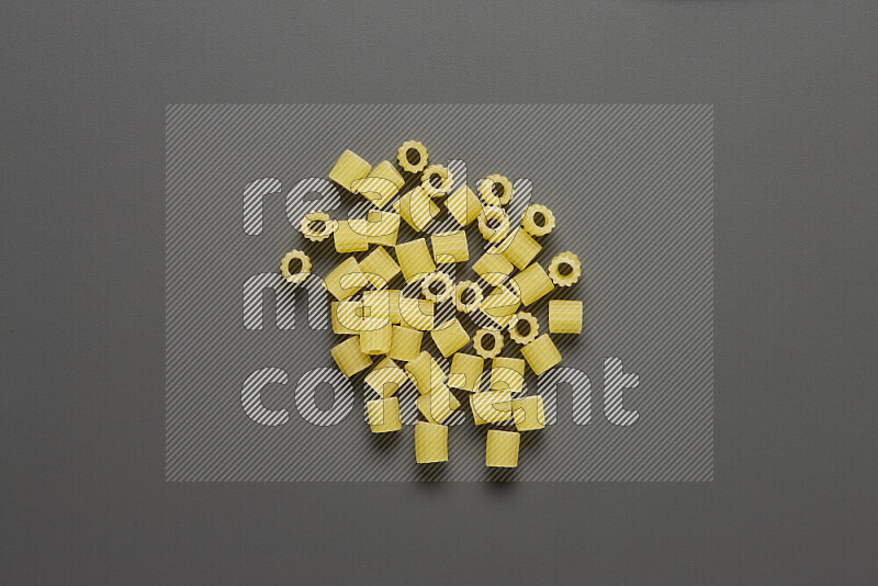 Small rings pasta on grey background