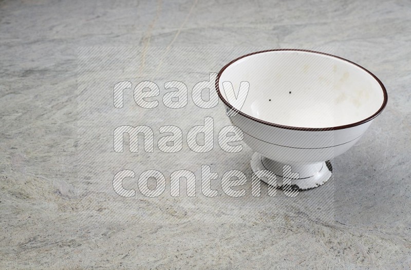 A Vintage Metal Pot On Grey Marble Flooring