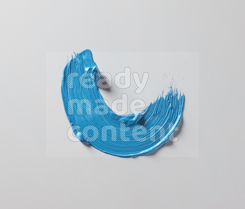 A single blue curved brush stroke on a white background