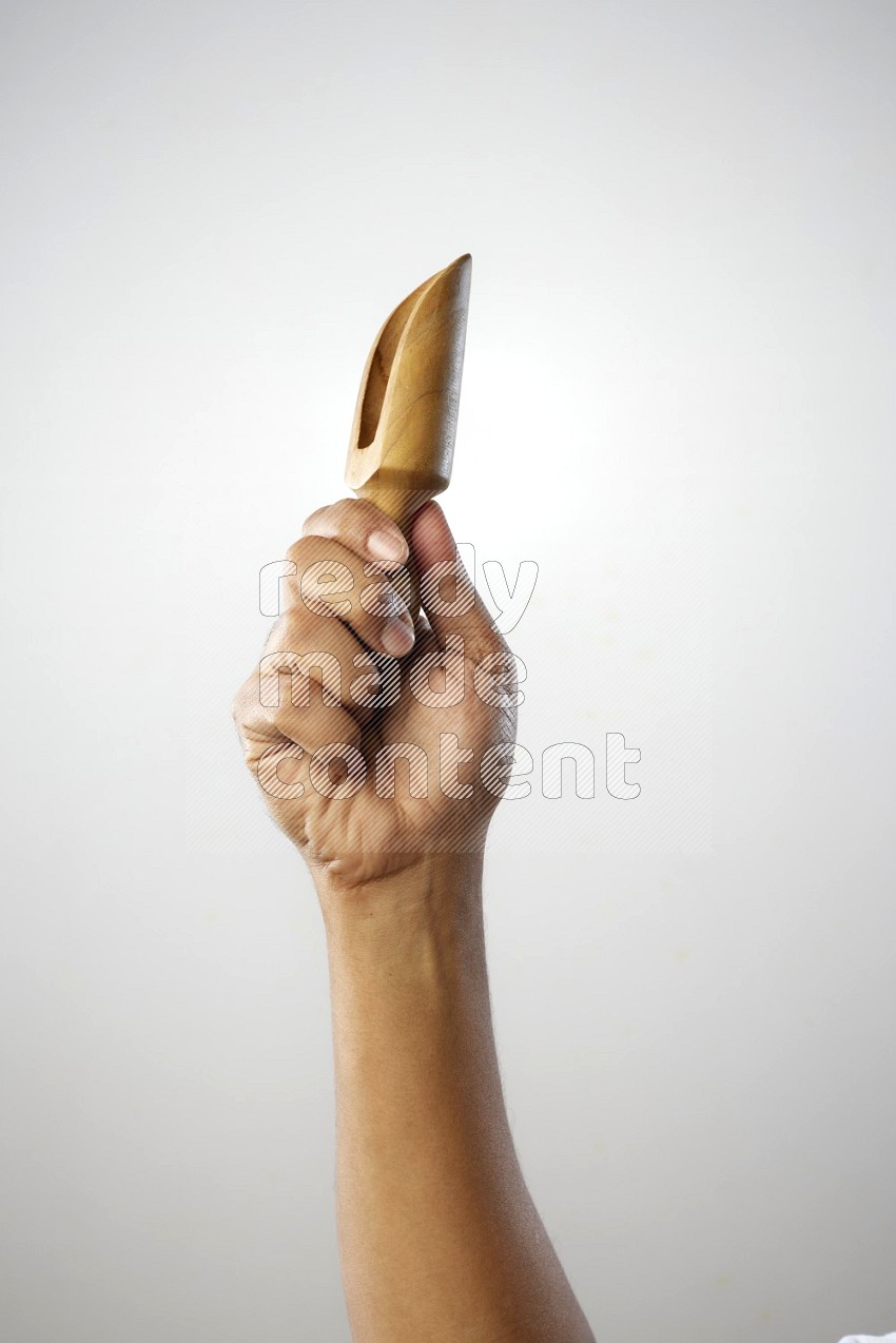 Male Hand Holding Wooden scoop
