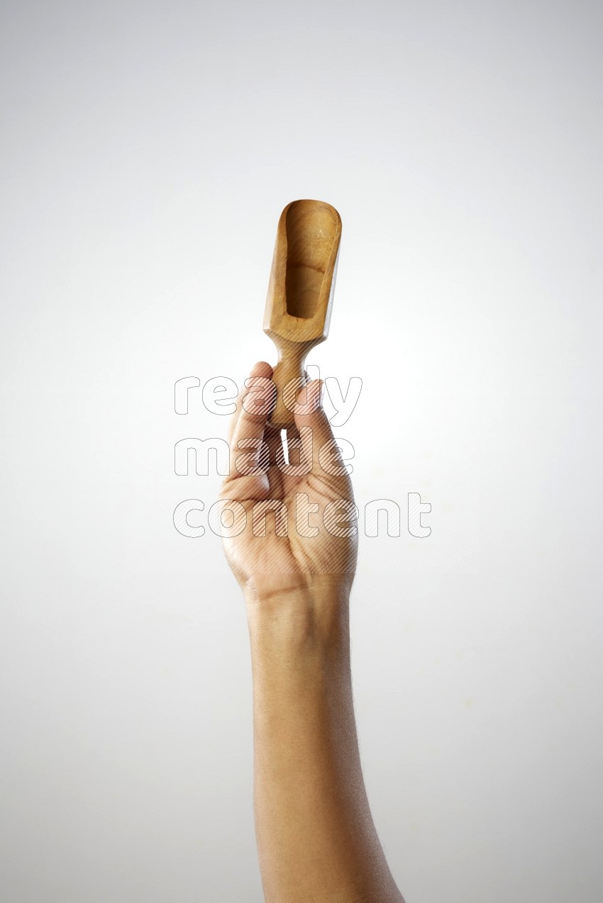 Male Hand Holding Wooden scoop