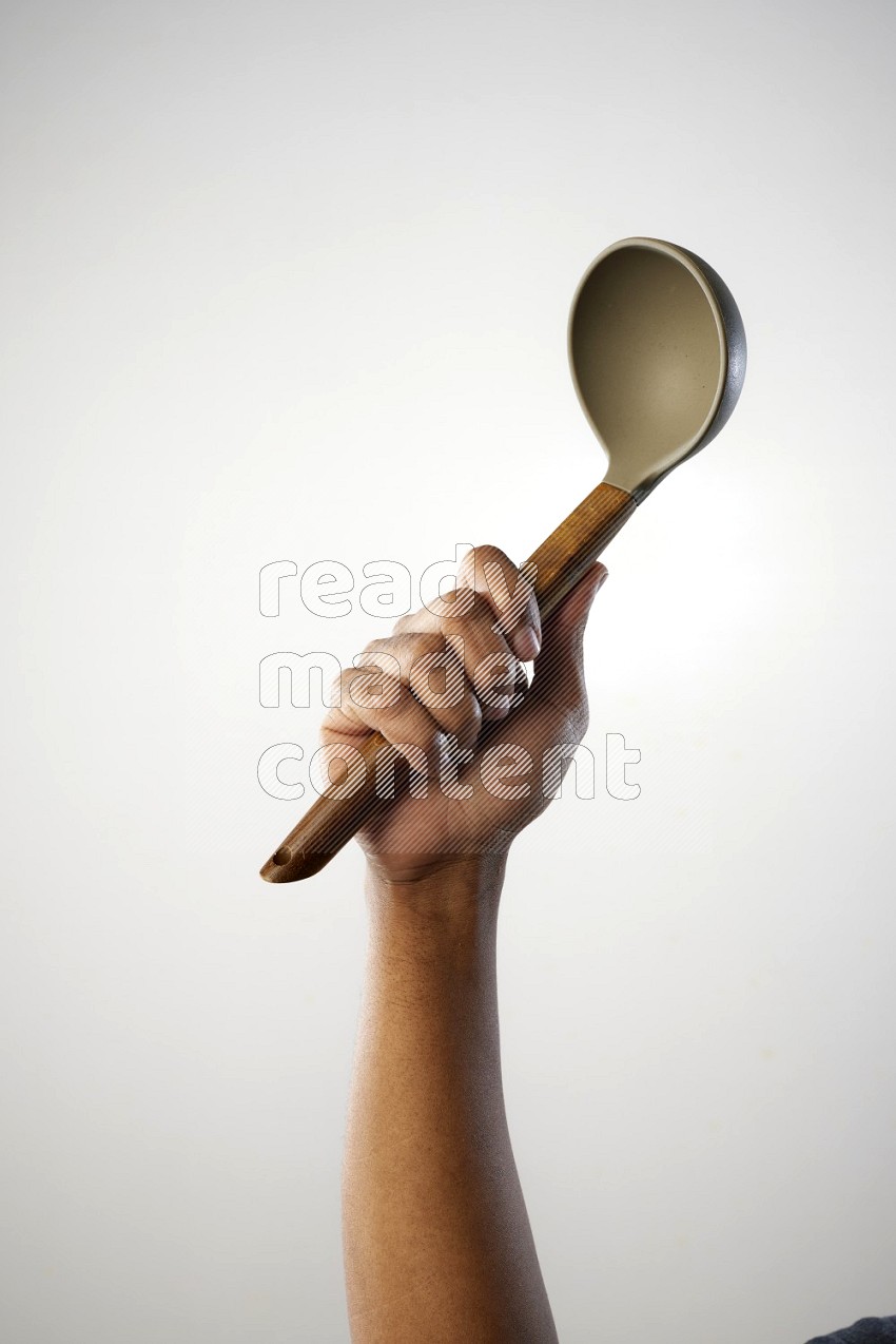 Male Hand Holding ladle on white background