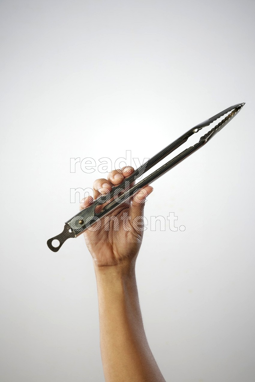 Male Hand Holding Tongs on white background