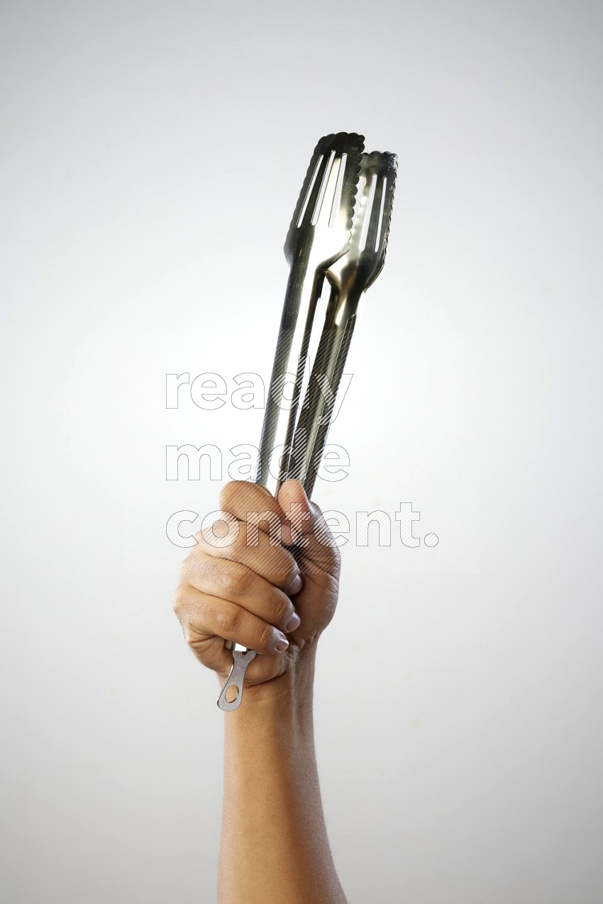 Male Hand Holding Tongs on white background