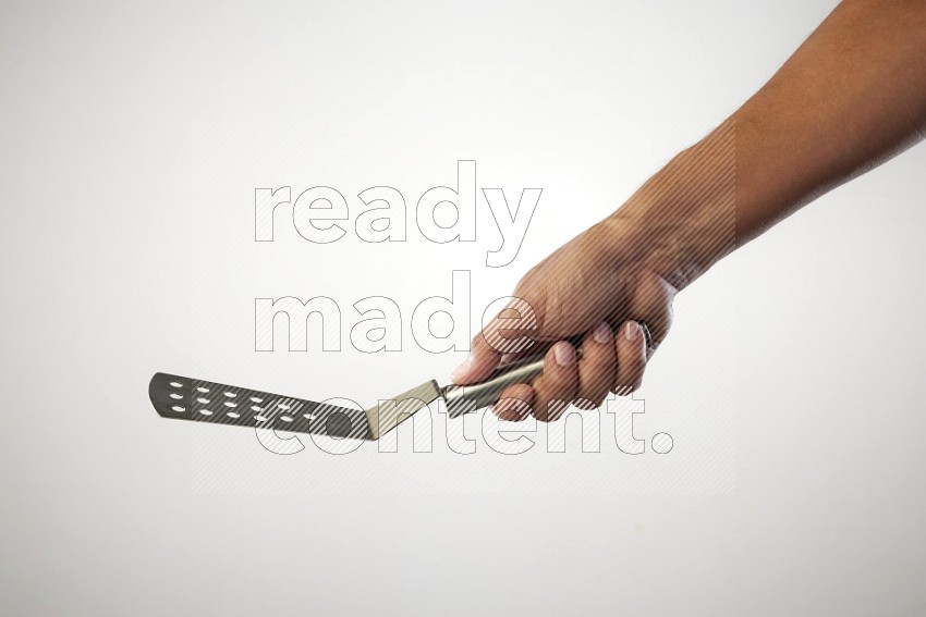 Male Hand Holding Burger Flipper on white background
