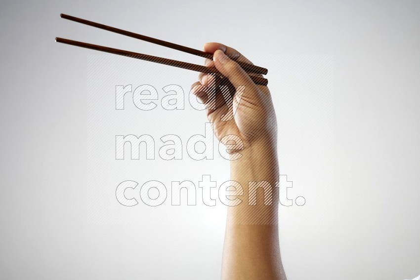 Male Hand Holding Chop Stick on white background