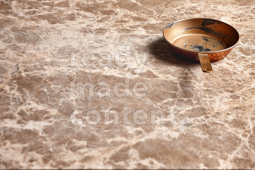 Small Copper Pan on Beige Marble Flooring, 45 degrees