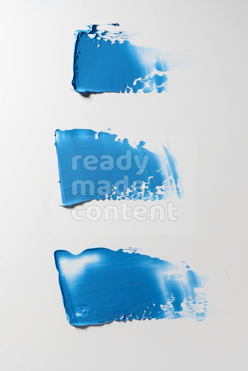 Blue painting knife strokes on a white background