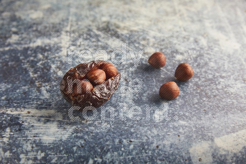hazelnuts stuffed majdoul date on a rustic blue background