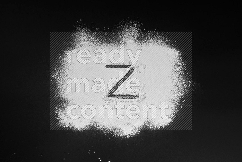 Alphabets written with powder on black background